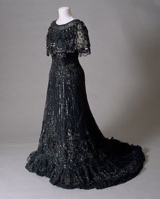  black dress with an accompanying black lace veil held in place by combs
